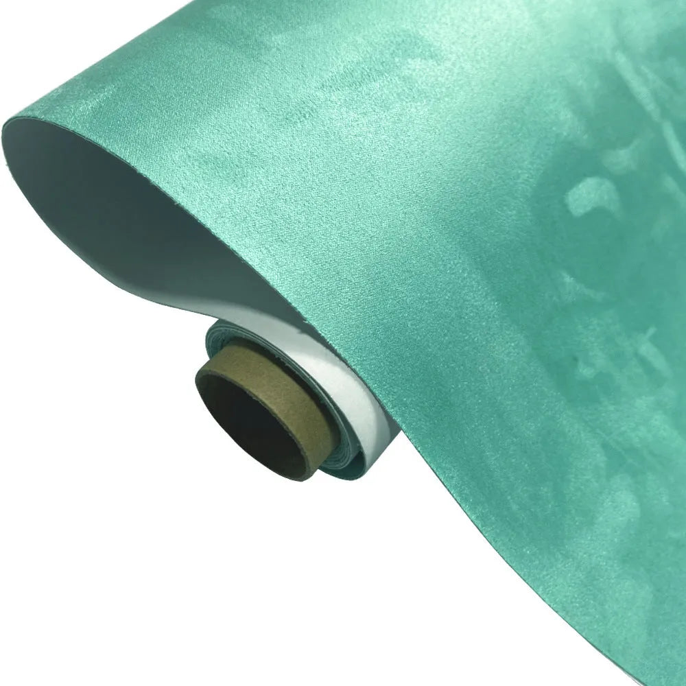 Rolls and sheets of coloured self-adhesive suede leather material for DIY projects.