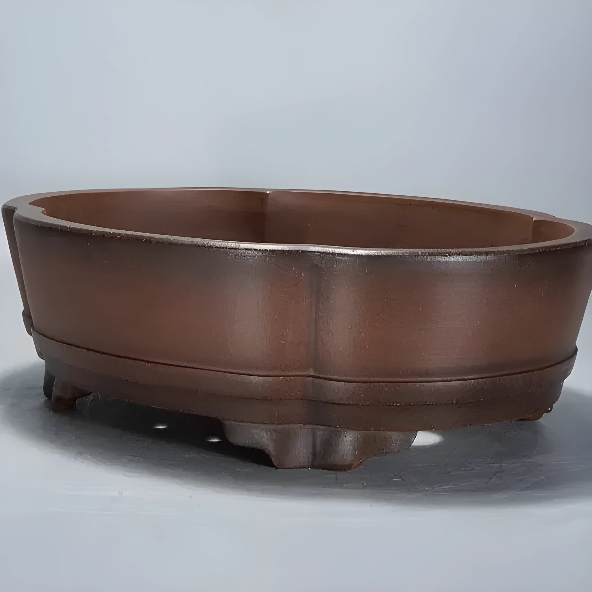 Green classical purple clay bonsai pot with low-profile rectangular shape on a tabletop.