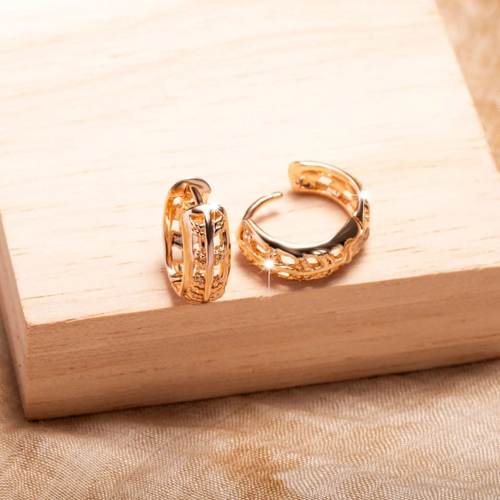 Rose gold hollowed copper earrings in leaf and heart shapes on a white background