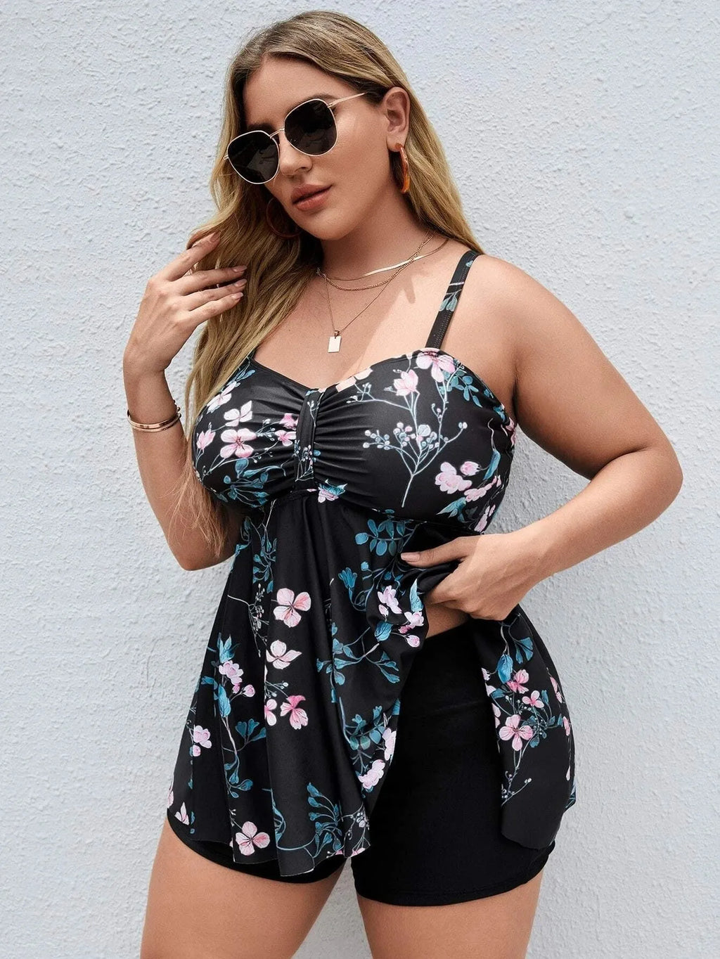 Women's one-piece floral print swimsuit with split colour design on a mannequin, showing high elasticity polyester fabric.