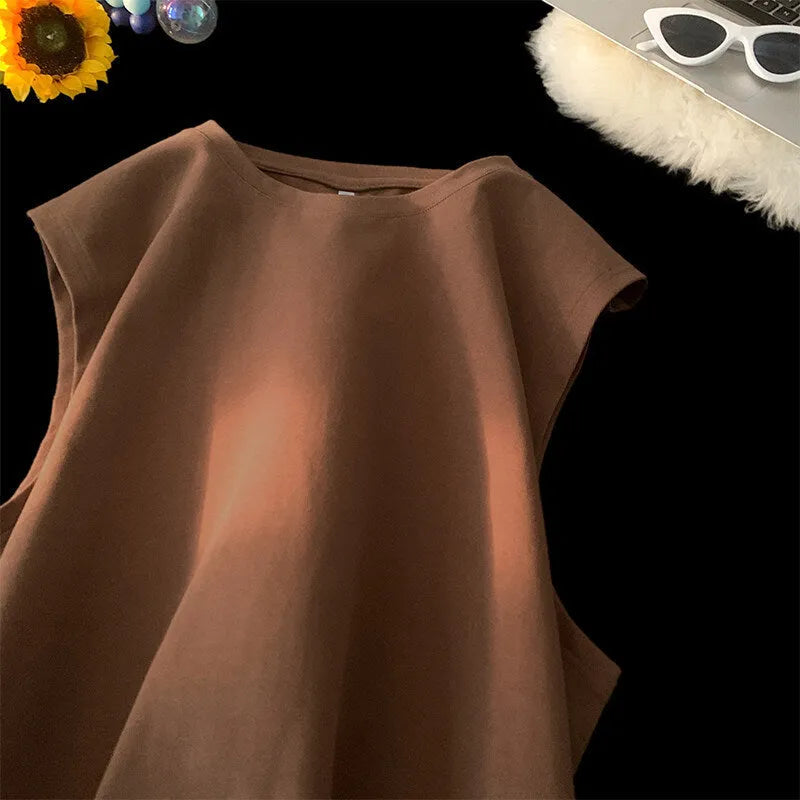 Men's loose-fitting solid colour cotton tank top on a hanger, shown in a light colour.