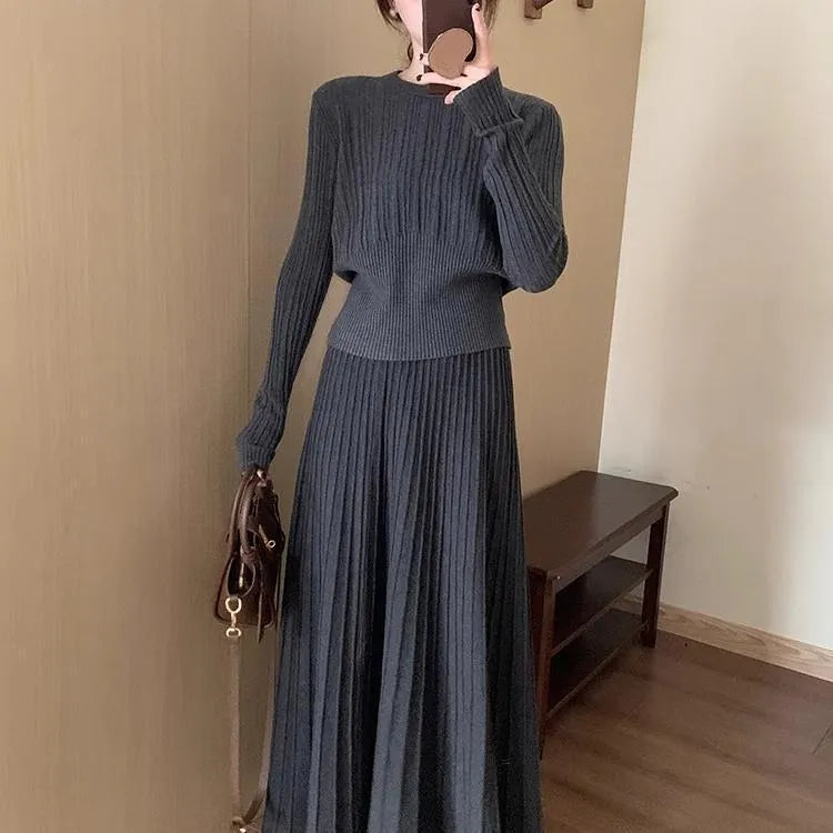 Dark grey knitted two-piece suit with 3D textured patterns, showing sweater and matching skirt