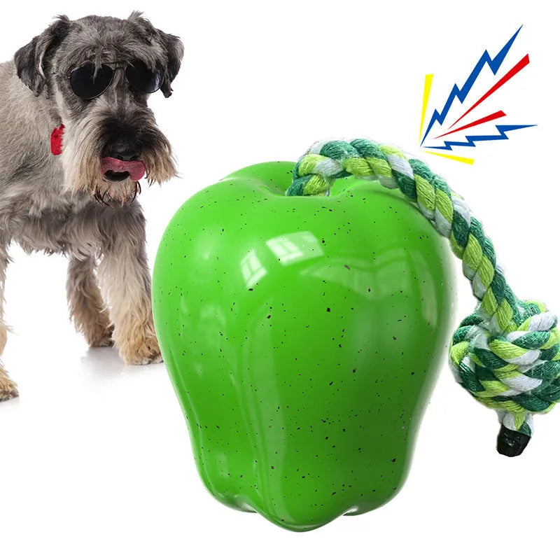 Plastic apple-shaped dog chew toy with molar texture and hollow centre for food dispensing.
