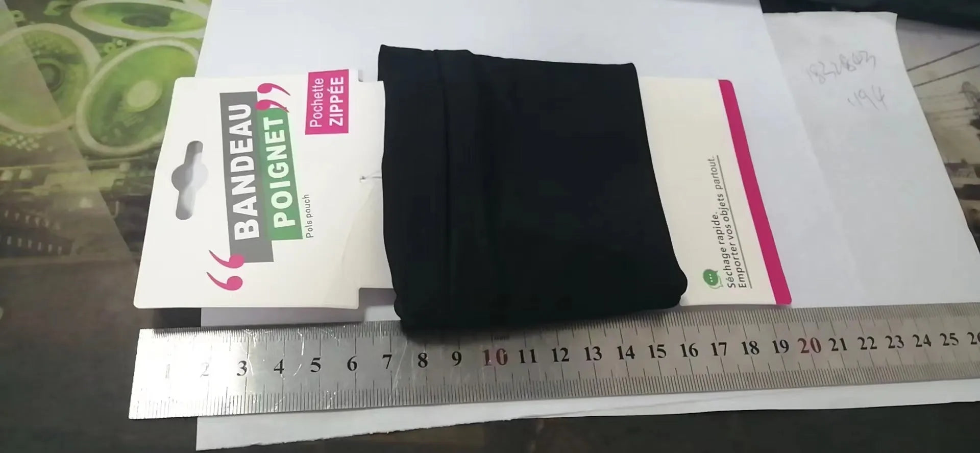 Black wrist bag armband sleeve for mobile phone storage, shown on a wrist.