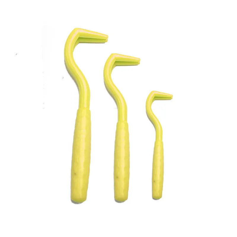 Set of three coloured plastic tick hook removal tools for dogs on a white background.