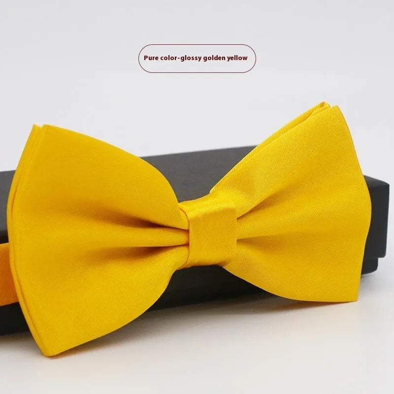 Solid colour flat head bow tie for formal wear in multiple colours including black, red, and blue.
