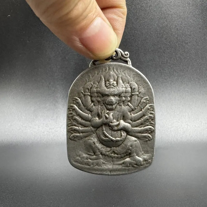 Close-up of a Chinese style iron wall pendant with geometric designs and Yamantaka figure.
