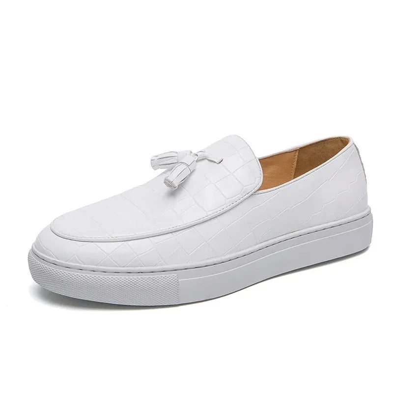 Men's plus size black slip-on sneakers with tassel detail and round toe on a rubber sole.
