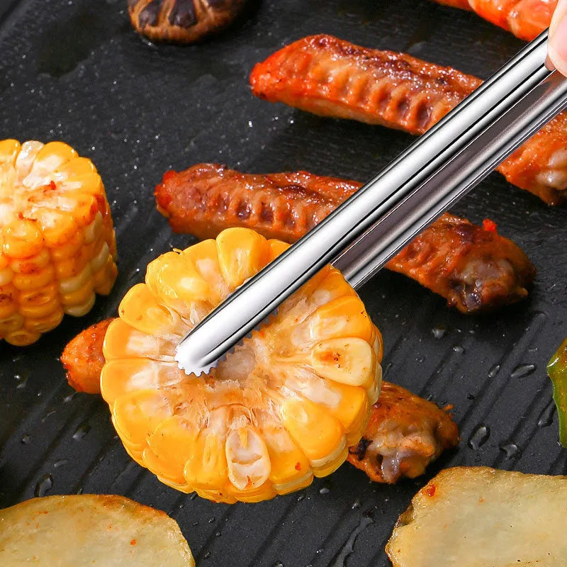 Stainless steel barbecue clamp in modern simple design on a table, showing the three size options small medium large