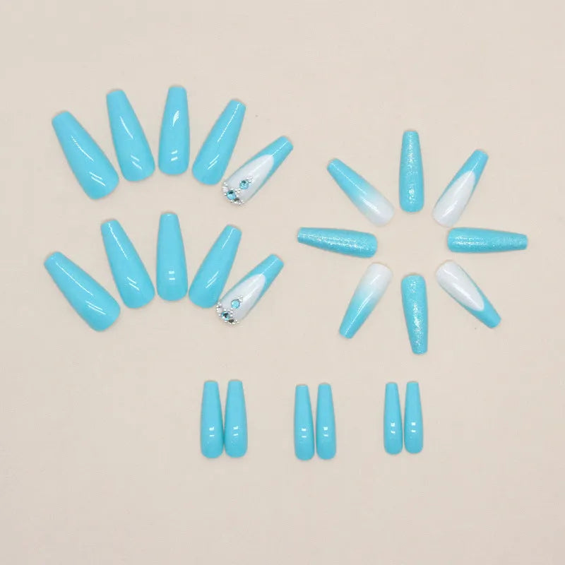 Solid colour long ballet false nails with blue diamond glitter accents and adhesive glue