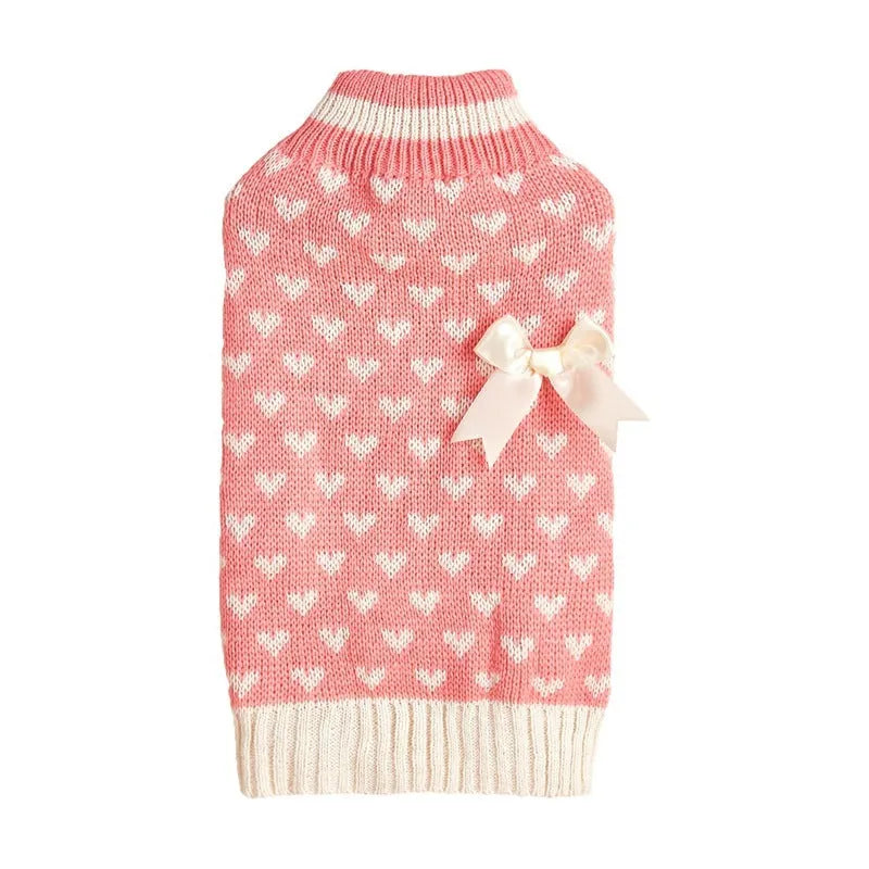Red dog sweater with a white love heart and bow design on a small dog.