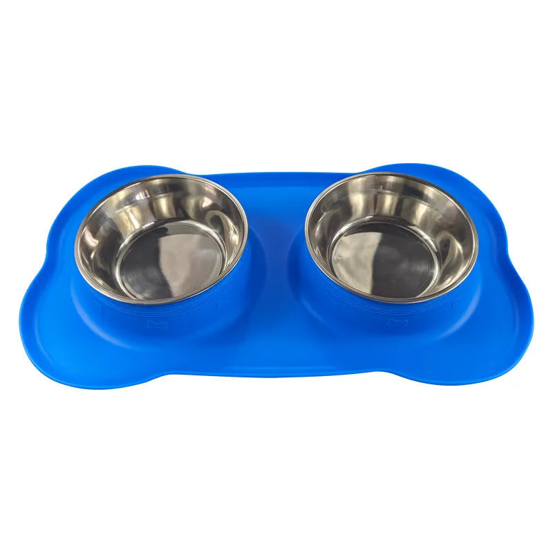 Large silicone double dog bowl in blue with two compartments for food and water on a kitchen floor.