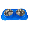 Large silicone double dog bowl in blue with two compartments for food and water on a kitchen floor.