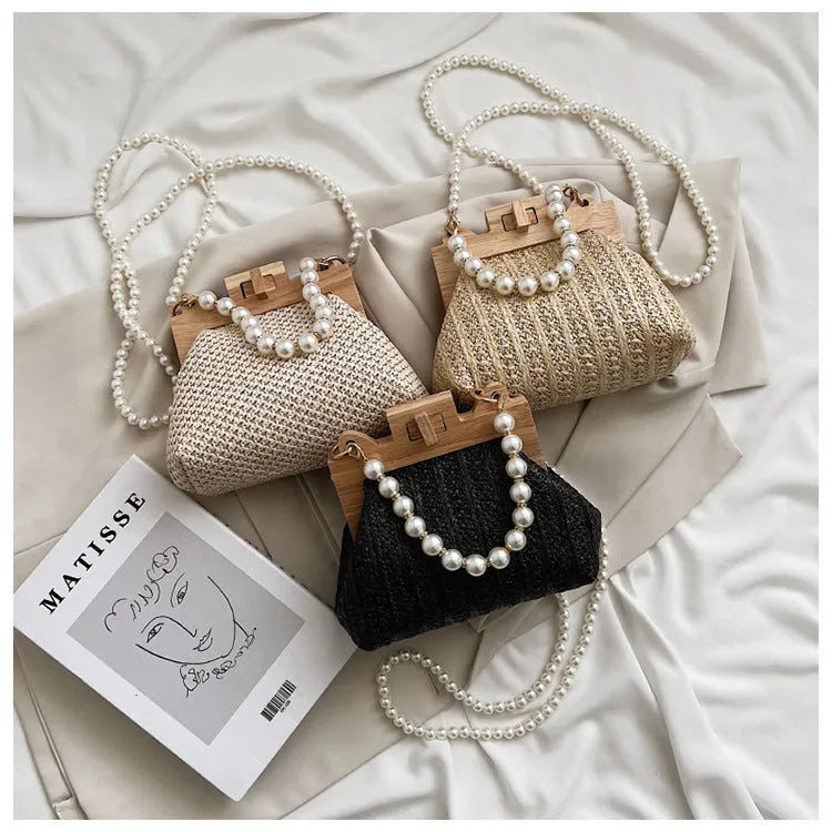 Women's woven straw shoulder bag with pearl chain strap in horizontal square shape