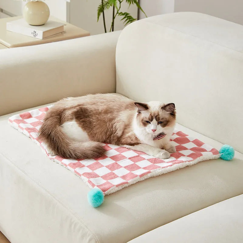 Green plaid pattern plush pet blanket for cats and dogs on a sofa