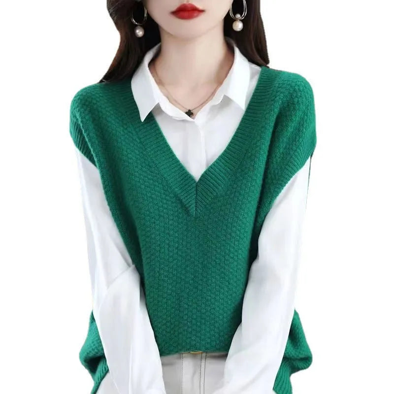 Women's creamy-white V-neck sleeveless knitted vest with a textured 3D pattern on a hanger.
