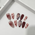 Hand-painted 3D carved manicure nails in almond colour and mid-length almond shape, showing rose and leopard print designs.