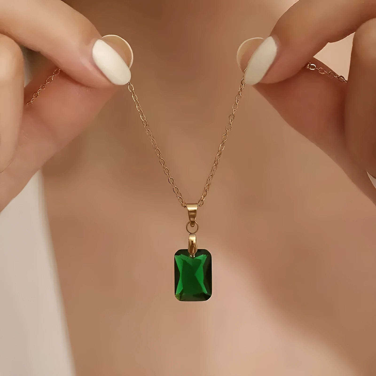 Copper geometric necklace with rectangular green pendant on an O-ring chain.