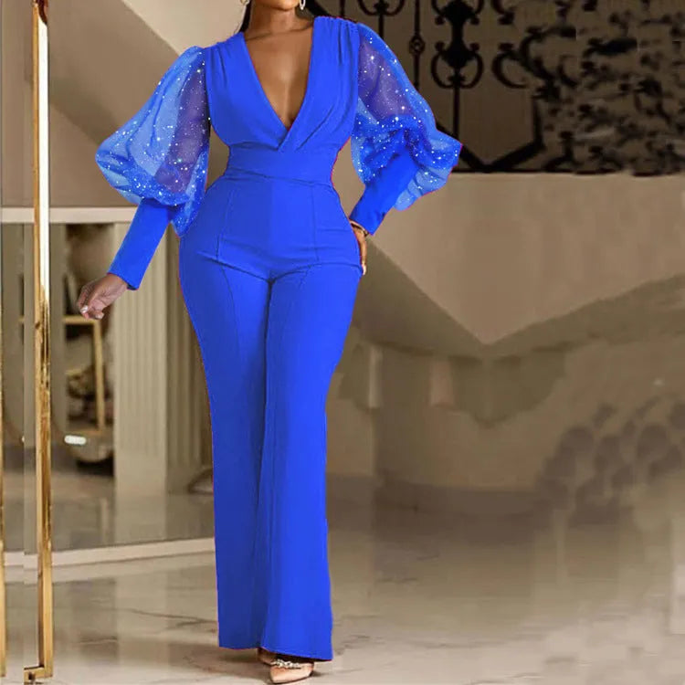 Red mesh stitch long sleeve jumpsuit with elastic waist and wide leg trousers on a hanger.
