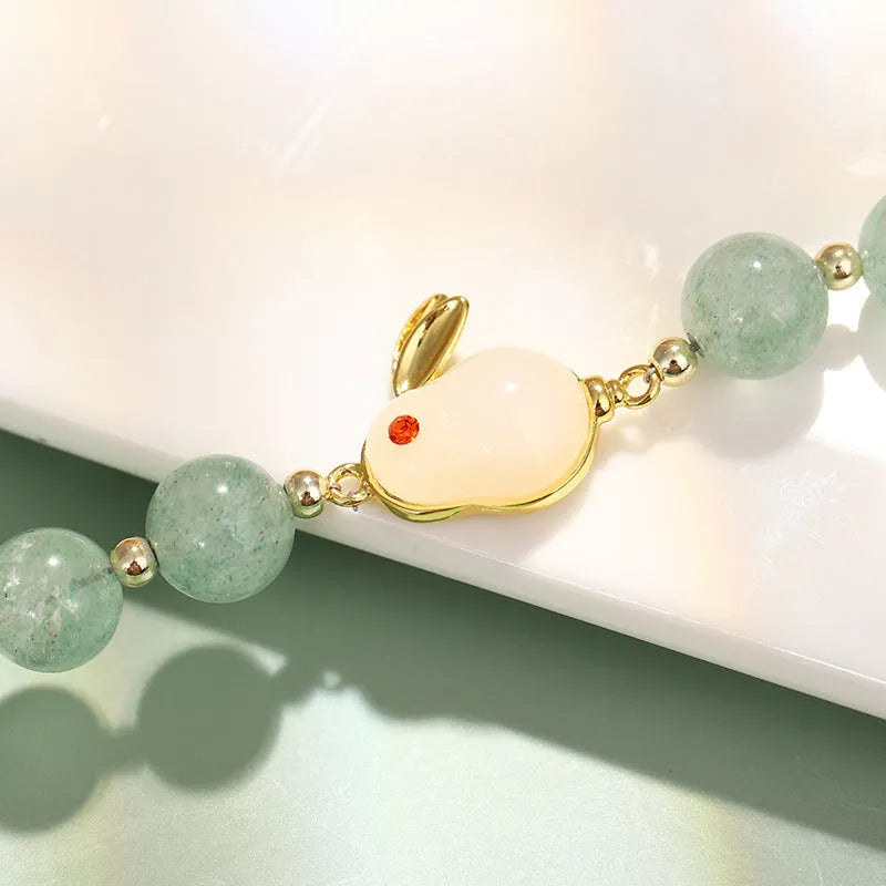 Green aventurine and strawberry quartz rabbit charm bracelet for women with copper and gold details