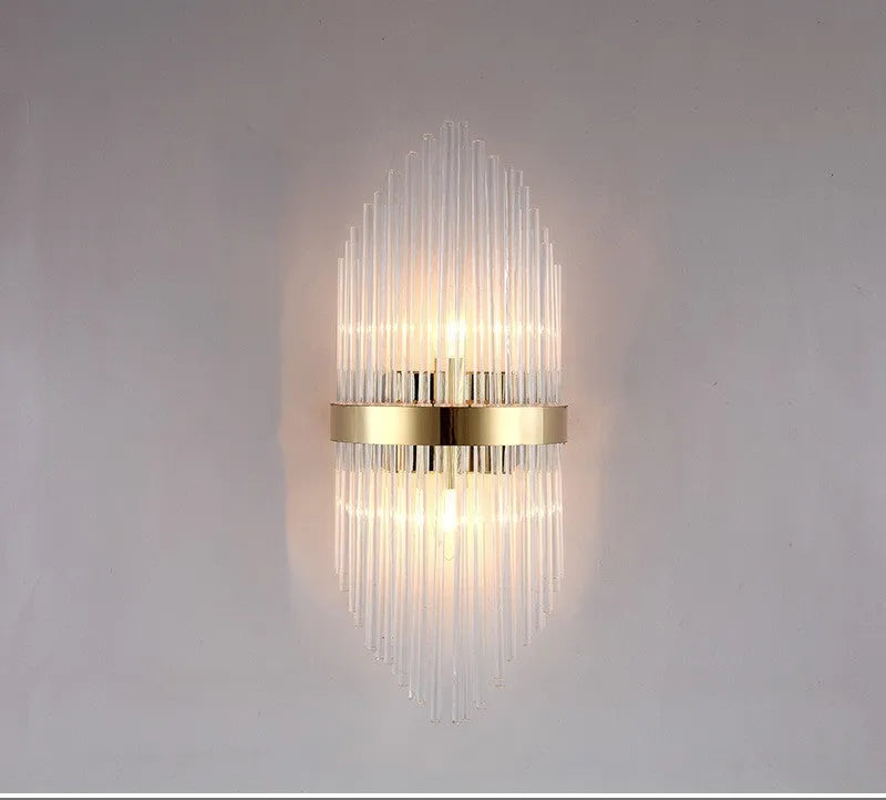 Modern crystal petal-shaped wall lamp in titanium gold finish mounted on a light-coloured wall.