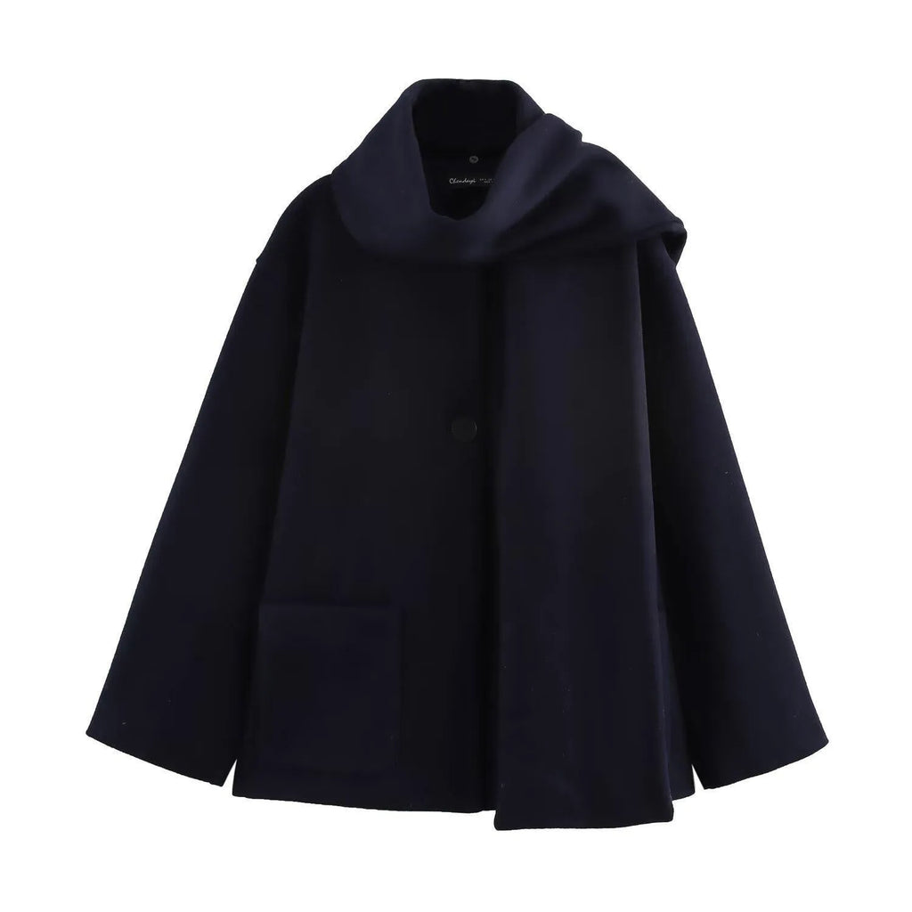 Women's long black polyester winter coat with a fluffy artificial fur collar, shown in a street fashion style.