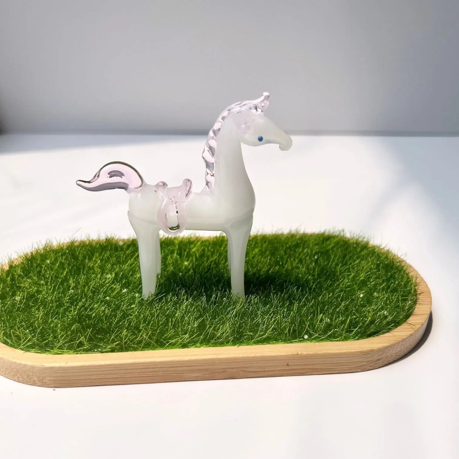 Glazed brown horse figurine on wooden desk as office decoration