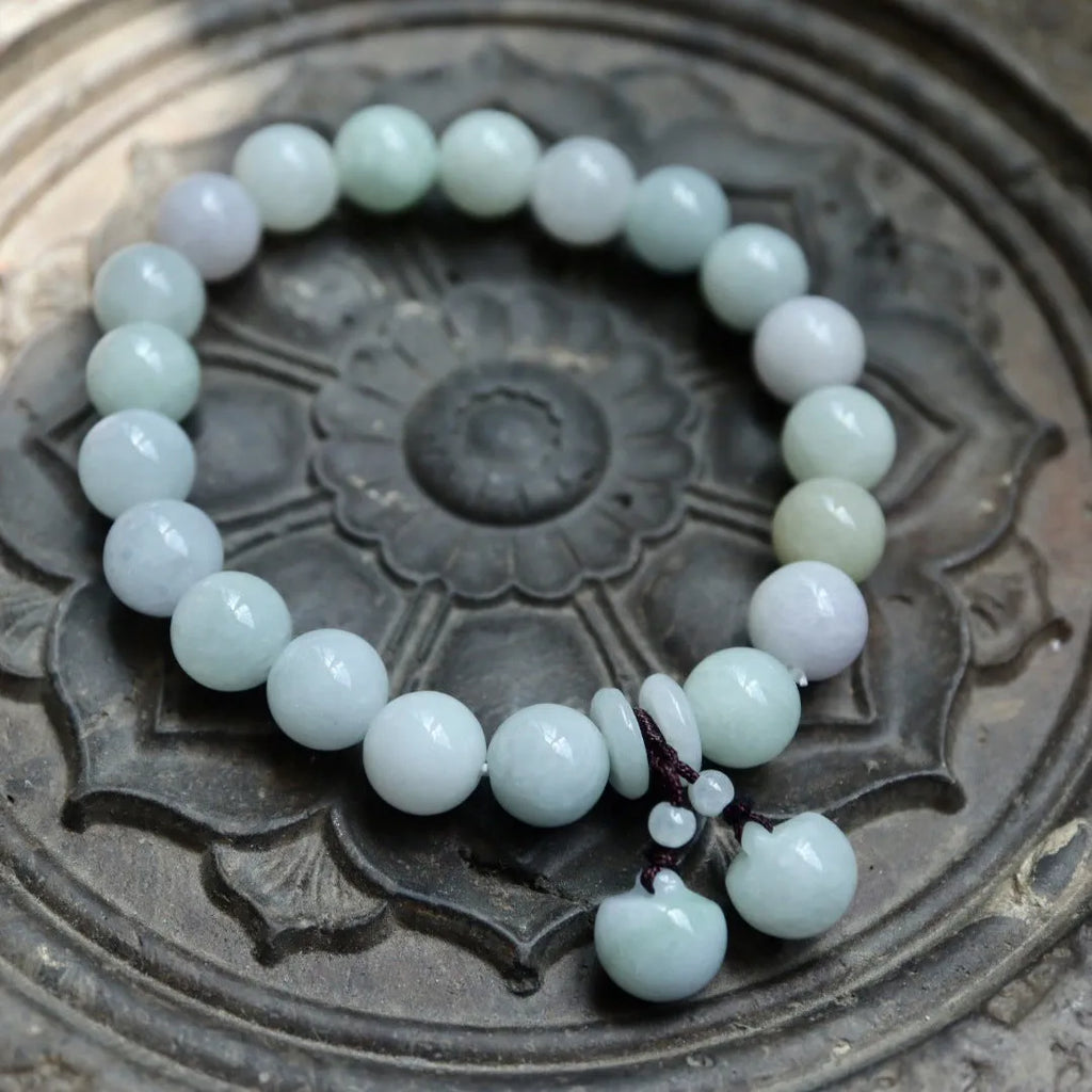 Natural green jade geometric bracelet with an adjustable chain and a hanging Maitreya Buddha charm.