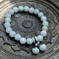 Natural green jade geometric bracelet with an adjustable chain and a hanging Maitreya Buddha charm.