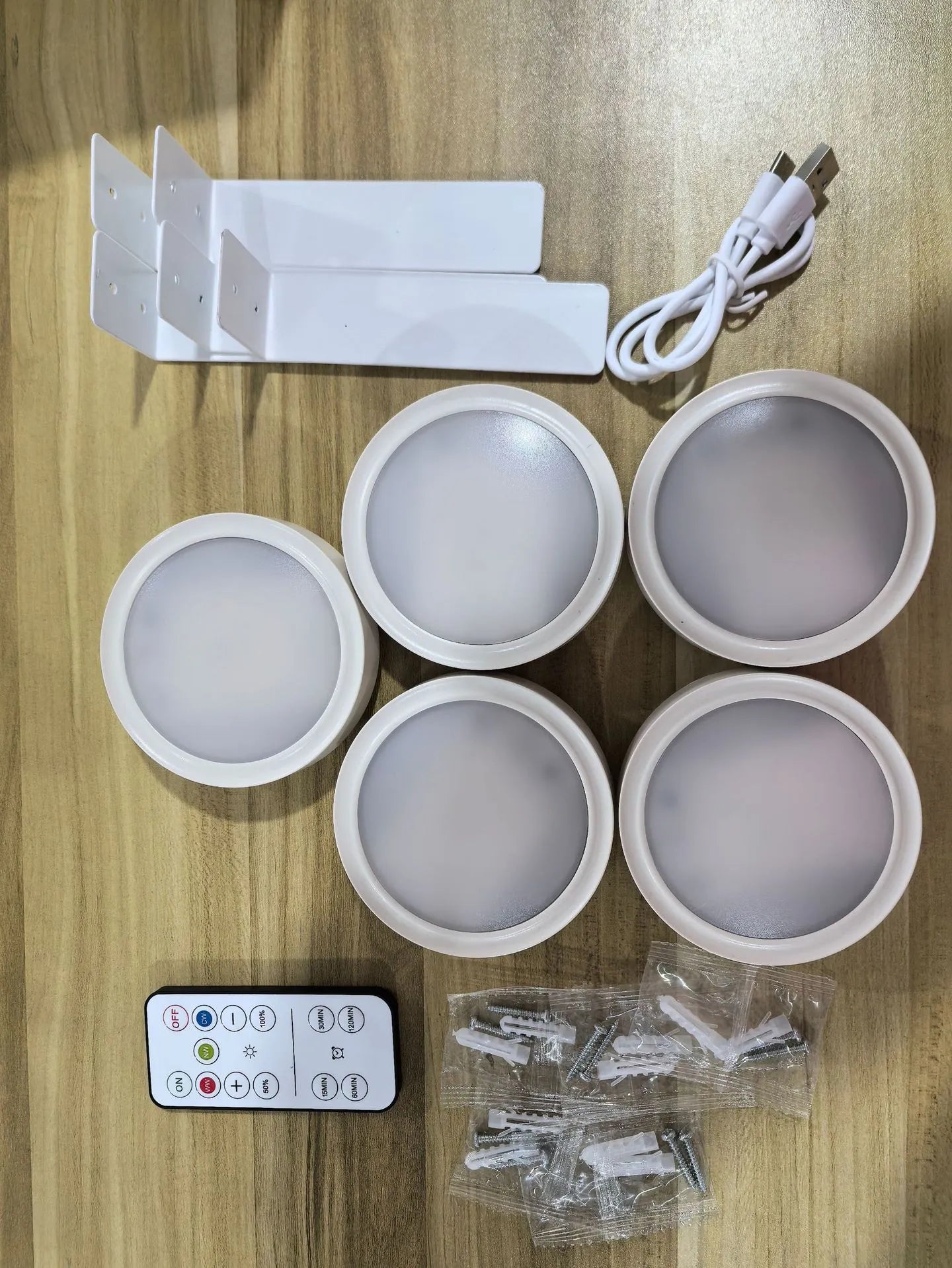 Wireless LED painting lamp with a magnetic mounting belt and remote control in black finish.