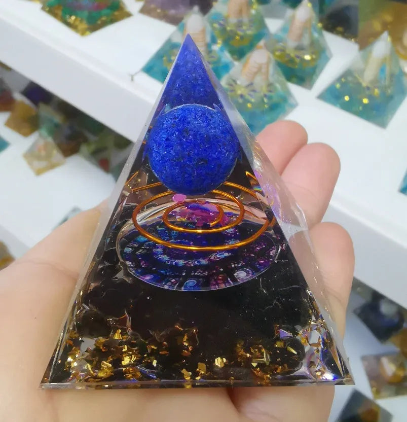 Clear epoxy resin pyramid ornament with embedded blue lapis lazuli crystal gravel, 6cm tall.