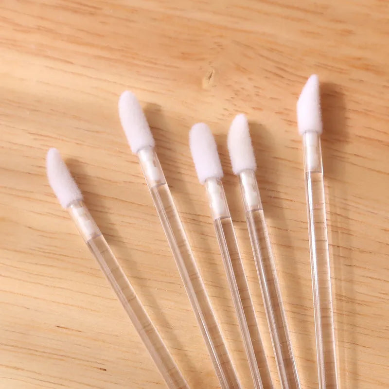 Pack of disposable lip brush applicators with coloured handles and flocked brush tips on a white background