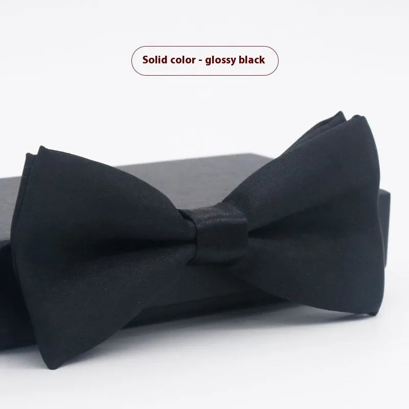 Solid colour flat head bow tie for formal wear in multiple colours including black, red, and blue.
