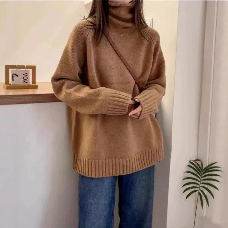 Women's loose grey turtleneck sweater with a thick, textured curling pile collar