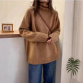 Women's loose grey turtleneck sweater with a thick, textured curling pile collar