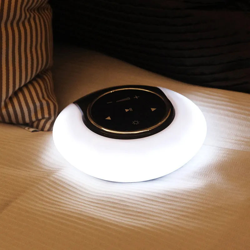Blue folding Bluetooth speaker desk lamp with touch controls showing white, yellow, and blue LED lighting options