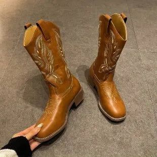 Brown women's Martin boots with embroidered toe cap and mid-calf height.