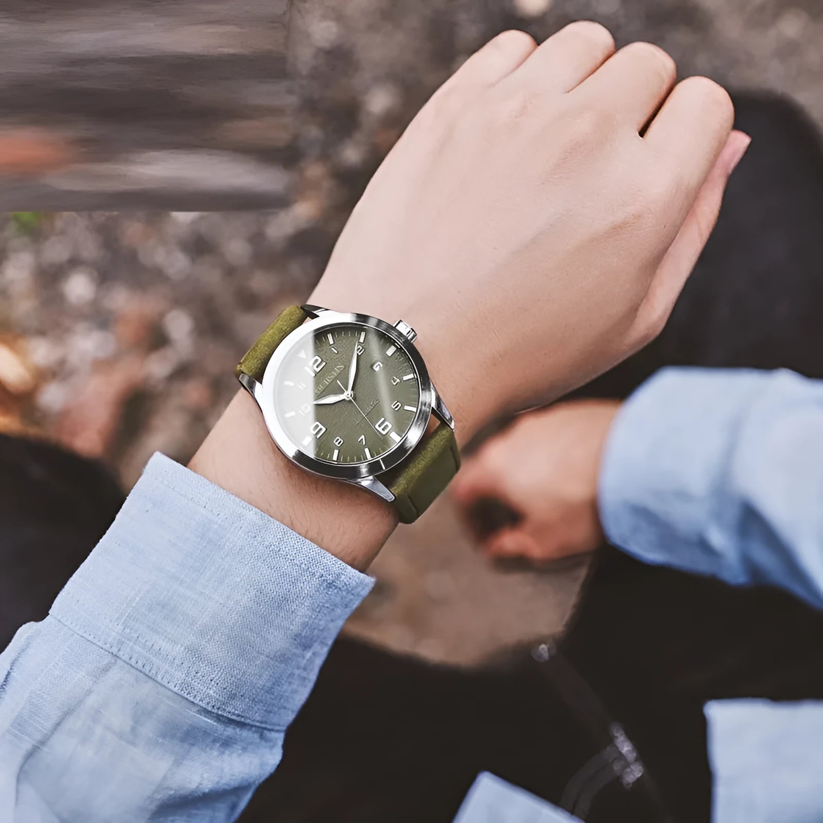 Men's silver case Army Green dial automatic watch with brown leather strap on wrist
