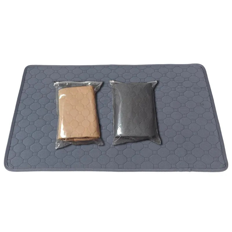Grey and khaki washable waterproof dog pee pad on a wooden floor next to a pet crate.