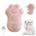 Blue self-cleaning cat grooming brush with silicone bristles and steam spray function on a pink background.