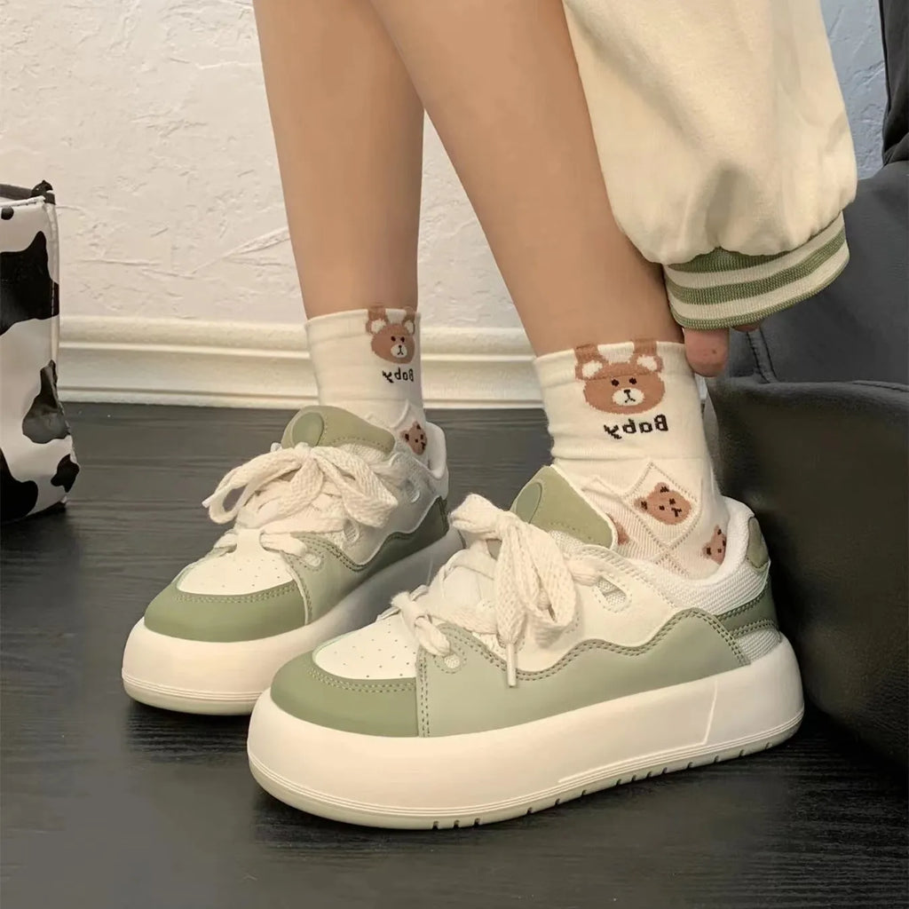 Green women's casual shoes with mesh upper, round toe, and flat non-slip sole.