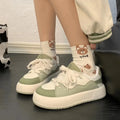 Green women's casual shoes with mesh upper, round toe, and flat non-slip sole.