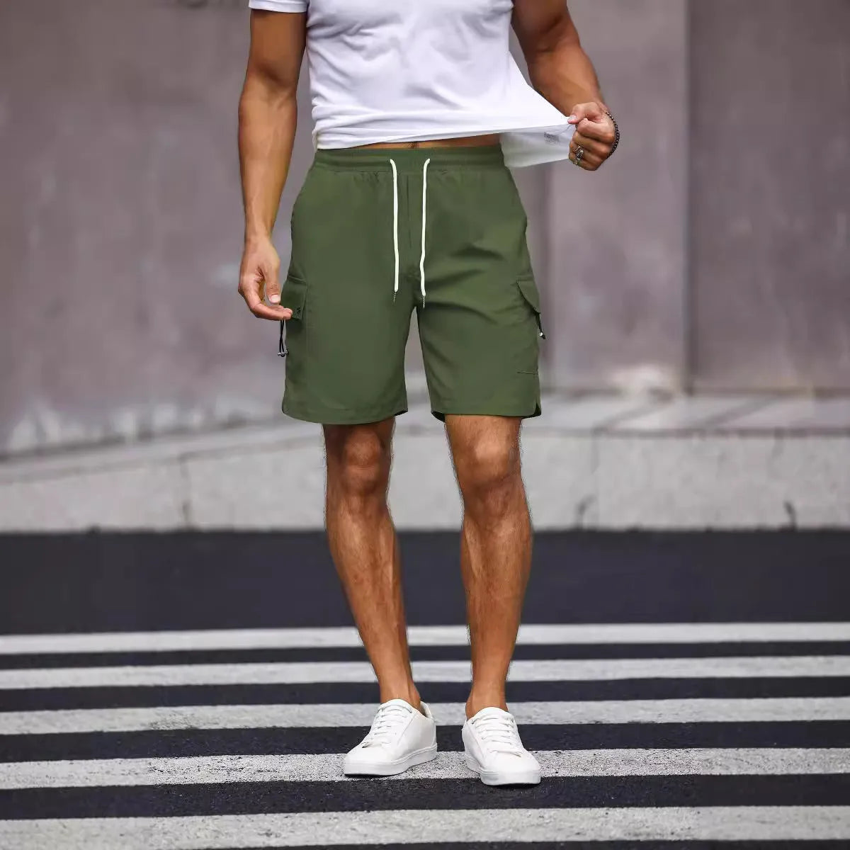 Men's loose fit workwear shorts in fluorescent green or army green with straight leg and fifth-pants length.