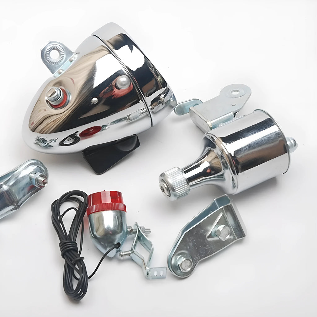 Silver bicycle dynamo generator light kit mounted on a bike frame with front and rear lights