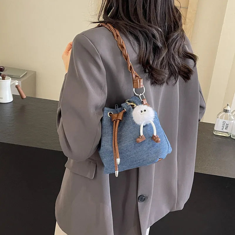 Blue cross body bucket messenger bag with synthetic leather lining and sandwich pocket organisation