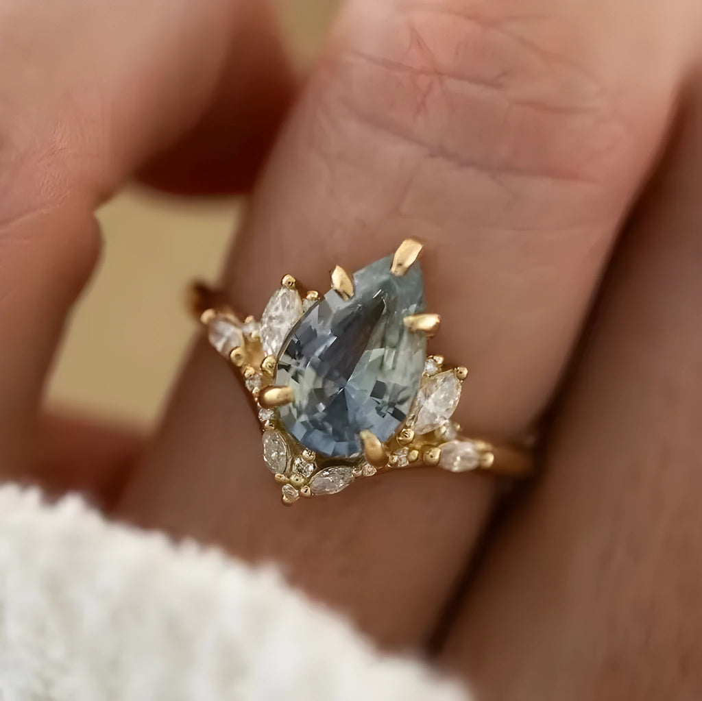 Gold alloy women's floral ring with blue crystal diamond inlay, side view