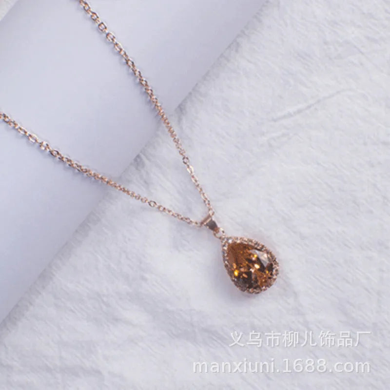 Rose gold geometric drop necklace with rhinestone details in pink colour option