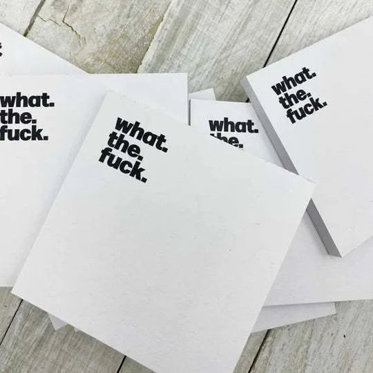 75mm square paper sticky note pad with funny English text cover designs on a desk.