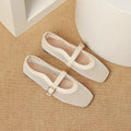 Women's beige mesh low heel pump with a buckle strap and square toe on a neutral background.