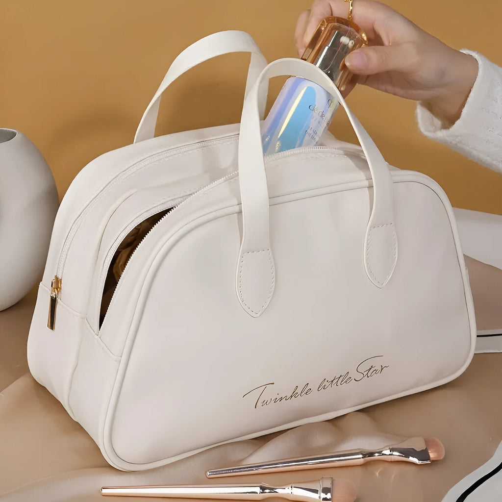 Large leather travel toiletry bag open to show dry and wet separation compartments.